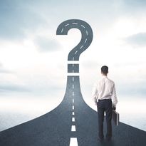 Business person looking at road with question mark sign concept